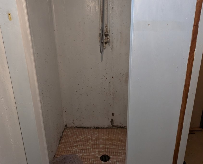 Old basement shower requiring renovation