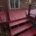 Freshly painted red wooden deck stairs and platform outside a brick house